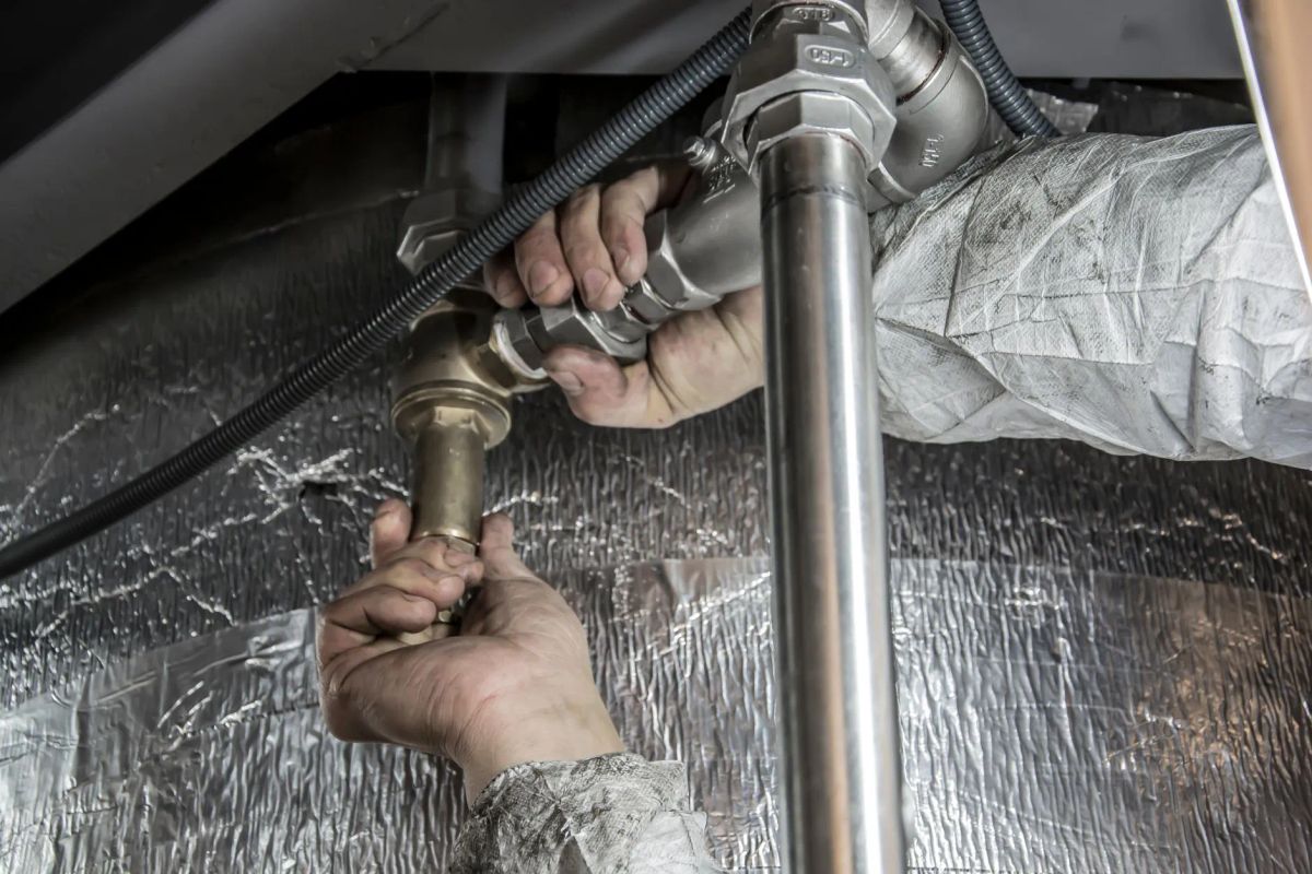 Peakstone plumber working on a plumbing repair in a Capitol Hill apartment